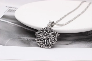 Detailed close-up of Saint Michael pendant in vintage silver steel on a box chain