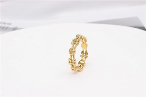 Detailed close-up of gold punk skull ring with interconnected skeleton bone design