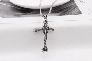 Detail of vintage Viking bone-shaped cross pendant in silver-tone stainless steel