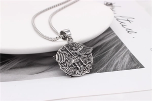 Detailed relief of Archangel Michael on a vintage silver steel pendant necklace