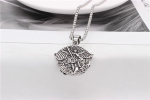 Macro shot of Archangel Michael vintage silver stainless steel pendant and chain necklace