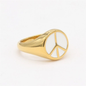 Gold signet ring with white enamel face featuring a central gold peace symbol
