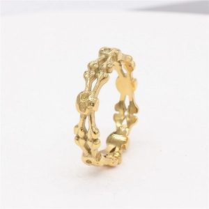 Gothic punk style hollow skull ring in polished gold finish with crossbone design