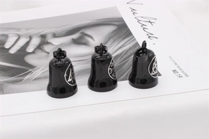 Close-up of black steel Viking bell pendants with silver Celtic knot rune engravings