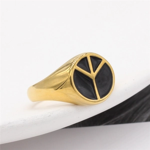 Gold stainless steel signet ring with a black peace symbol, modern minimalist style