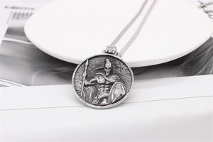 Macro detail of vintage Spartan warrior embossed pendant in silver finish