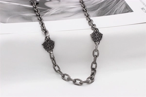 Detailed close-up of retro titanium steel necklace with winged angel relief charms