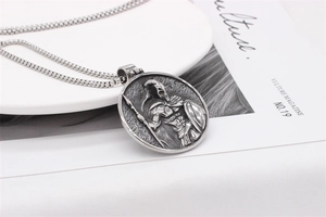 Macro detail of retro Spartan warrior relief on silver stainless steel pendant