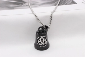 Detail view of a vintage Nordic Viking bell pendant with Celtic Triquetra on a box chain