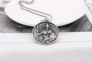 Detailed relief of a Spartan warrior on a silver steel pendant with antique finish