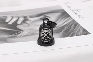 Detailed close-up of a Viking Vegvisir compass bell pendant on a fashion magazine