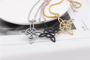 Detailed view of Celtic knot necklaces in silver, black, and gold on a white surface