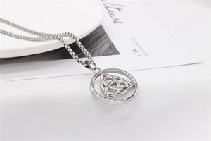 Close-up of a silver Triquetra Celtic knot pendant on a box chain for men