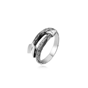 Macro shot of retro stainless steel arrow ring with vintage oxidized finish and texture