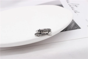 Detailed view of vintage silver arrow-shaped wrap ring with retro engraved textures
