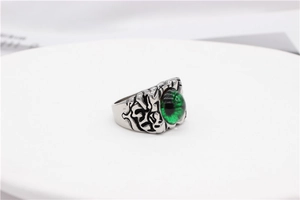 Macro shot of vintage evil eye ring with realistic green iris and antique silver finish