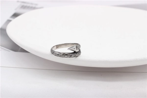 Detailed view of vintage silver steel ring featuring thorn textures and arrow design
