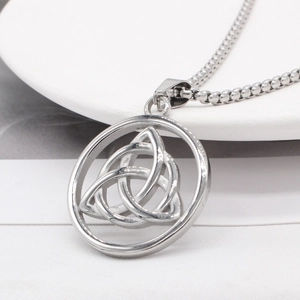 Vintage Viking Triquetra pendant necklace in polished silver steel on white fabric
