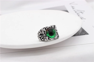 Macro shot of punk gothic steel ring with detailed green devil eye and vintage finish