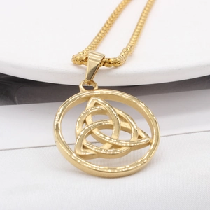 Golden Celtic Triquetra knot pendant with box chain on a white display plate