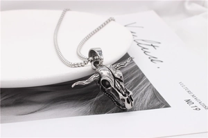Macro detail of retro punk bull skull pendant with vintage silver finish and chain