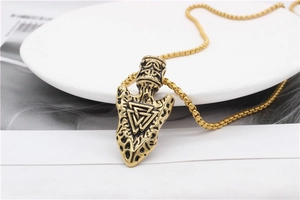 Macro shot of Viking Valknut arrow pendant with antique gold finish and square chain link