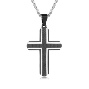 Detail of silver cross pendant with black mesh texture inlay and polished metal edges