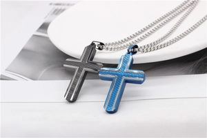 Detail of cross pendants with diamond pattern texture in black and blue finishes