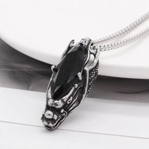 Retro stainless steel dragon head necklace featuring a faceted black gemstone pendant