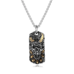 Macro detail of gothic horned skull pendant in antique silver with gold accents