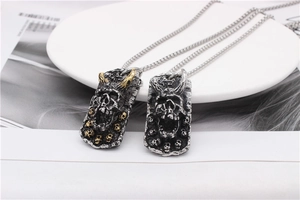 Macro detail of gothic skull pendants with horns in gold and silver finishes