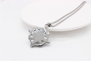 Macro shot of silver octagonal star pendant with box chain on a ceramic plate