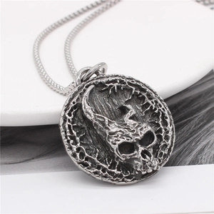 Vintage silver skull pendant necklace with intricate round relief on a box chain for men