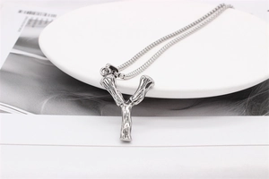 Detailed view of silver stainless steel Y-pendant necklace with lava texture on white tray