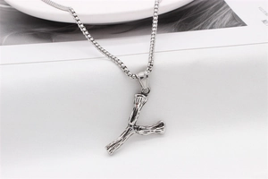 Close-up of vintage silver letter Y pendant with unique bone-like texture on box chain