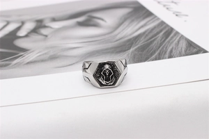 Macro shot of gothic silver men's signet ring with hooded reaper and geometric carving