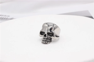 Macro view of vintage skull ring with black aged detailing on silver stainless steel