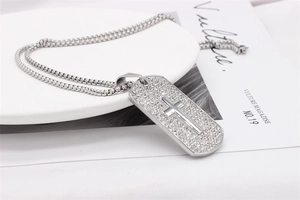Détail d'un collier plaque militaire croix argentée avec strass sur une assiette en céramique