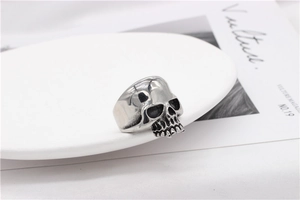 Macro shot of punk style skull ring with vintage oxidized finish and polished details