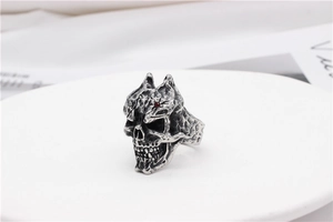 Macro detail of punk skull ring in vintage silver finish with a small red gemstone inlay