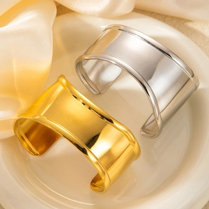 Polished wide open cuff bracelets in 18k gold and silver plating with sleek concave design
