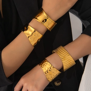 Polished wide gold stainless steel bangles with hammer and stripe texture for women