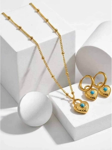 Detail of vintage heart-shaped jewelry set with blue turquoise on geometric props