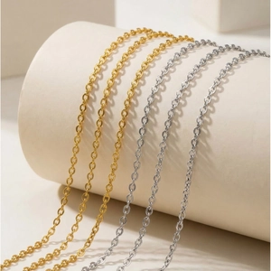 Minimalist 2mm stainless steel O-link chains in gold and silver plating on pedestals