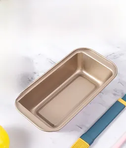 Close-up of champagne gold non-stick rectangular loaf pan on white marble surface