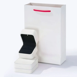 Luxury white LED jewelry box and matching gift bag with red handles for ring packaging