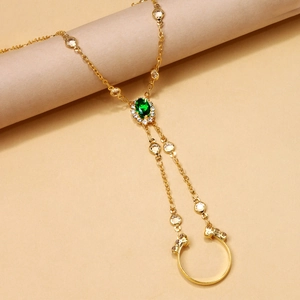 Vintage gold slave bracelet with green oval gemstone and dainty chain finger ring