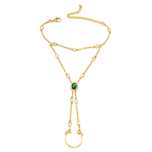 Vintage gold slave bracelet with emerald green stone and sparkling rhinestones