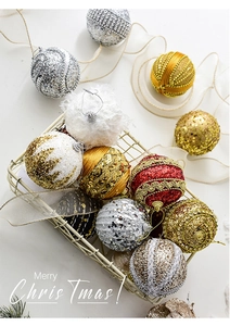 Detailed view of mixed Christmas ornaments with glitter, pearls and sequins in a wire basket
