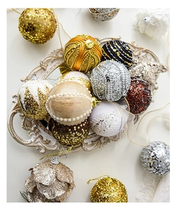 Close-up of assorted gold and silver Christmas ornaments with sequins and glitter detail